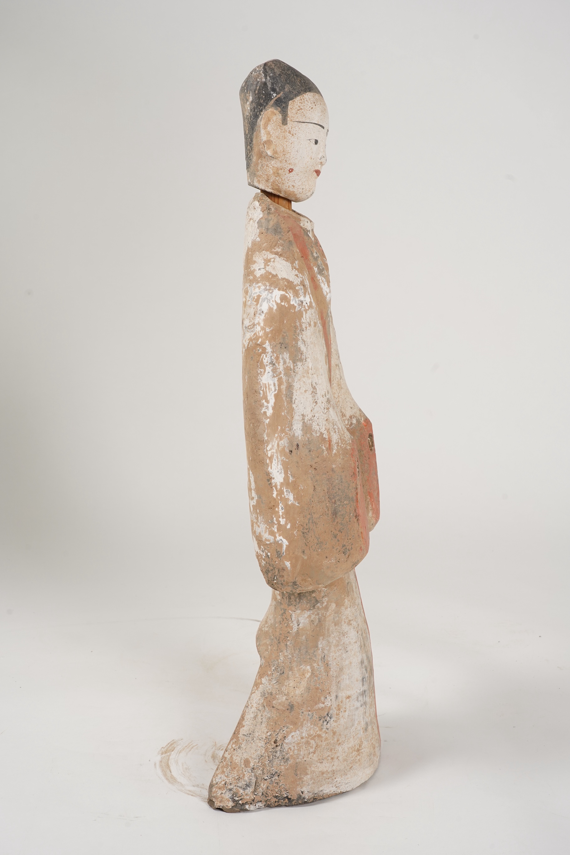 A large Chinese polychrome pottery figure of a female attendant, Han dynasty or later